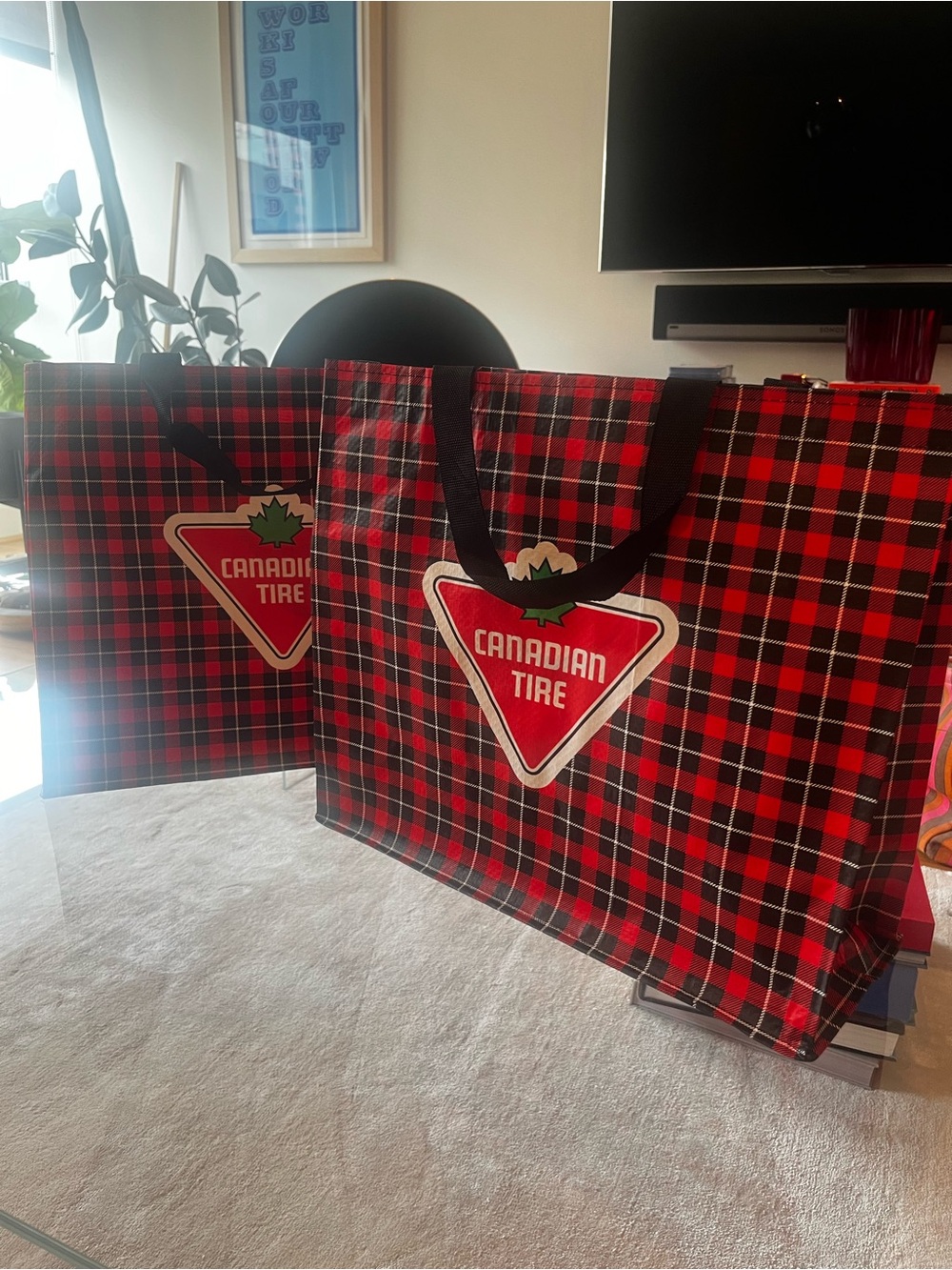 Two Canadian Birkin red and black shopping bags from Canadian Tire